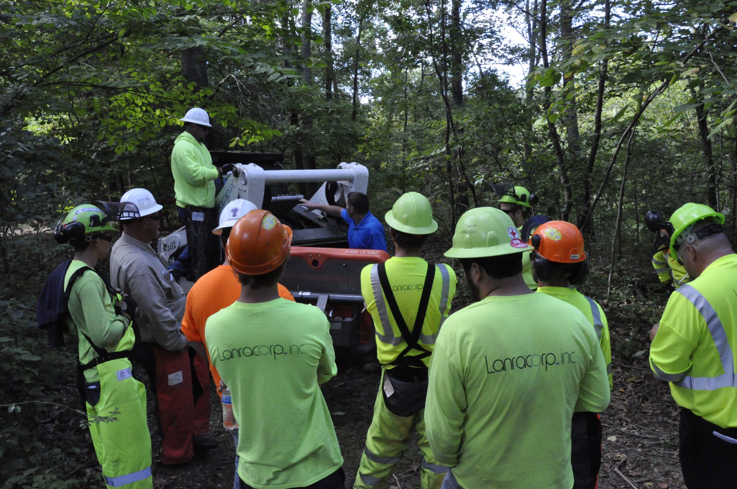 Men standing around a work truck in hard hats and PPE