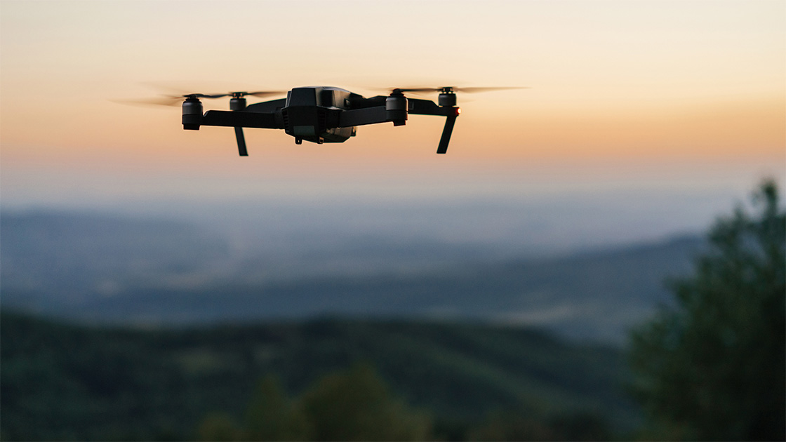 Drone flying over field